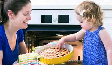 Women and girl with a cake